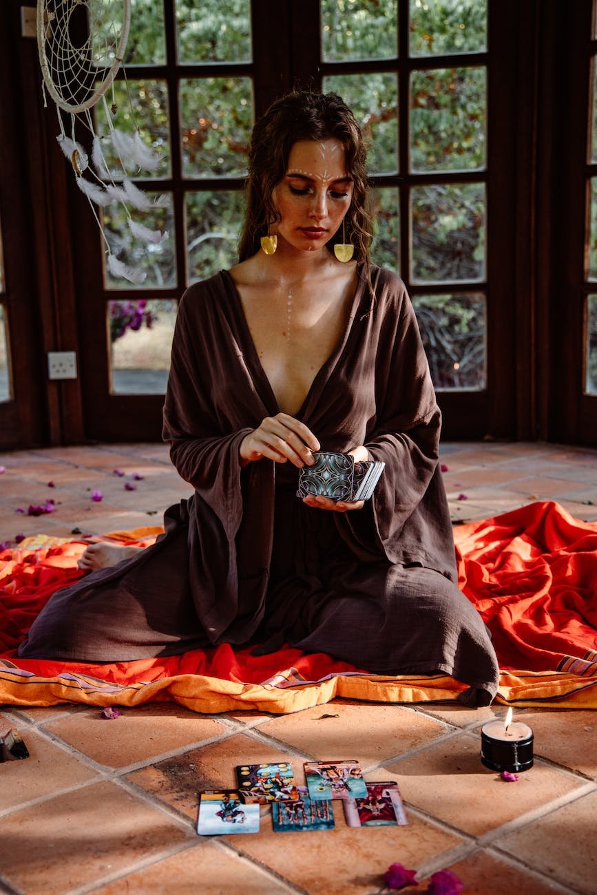 a woman holding a deck of tarot cards