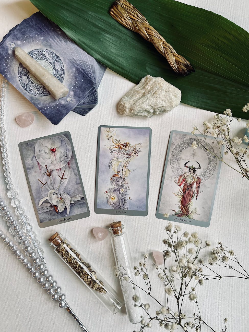 beautiful tarot spread on table with herbs and crystals