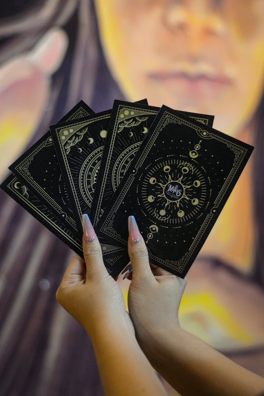close up of woman holding tarot cards