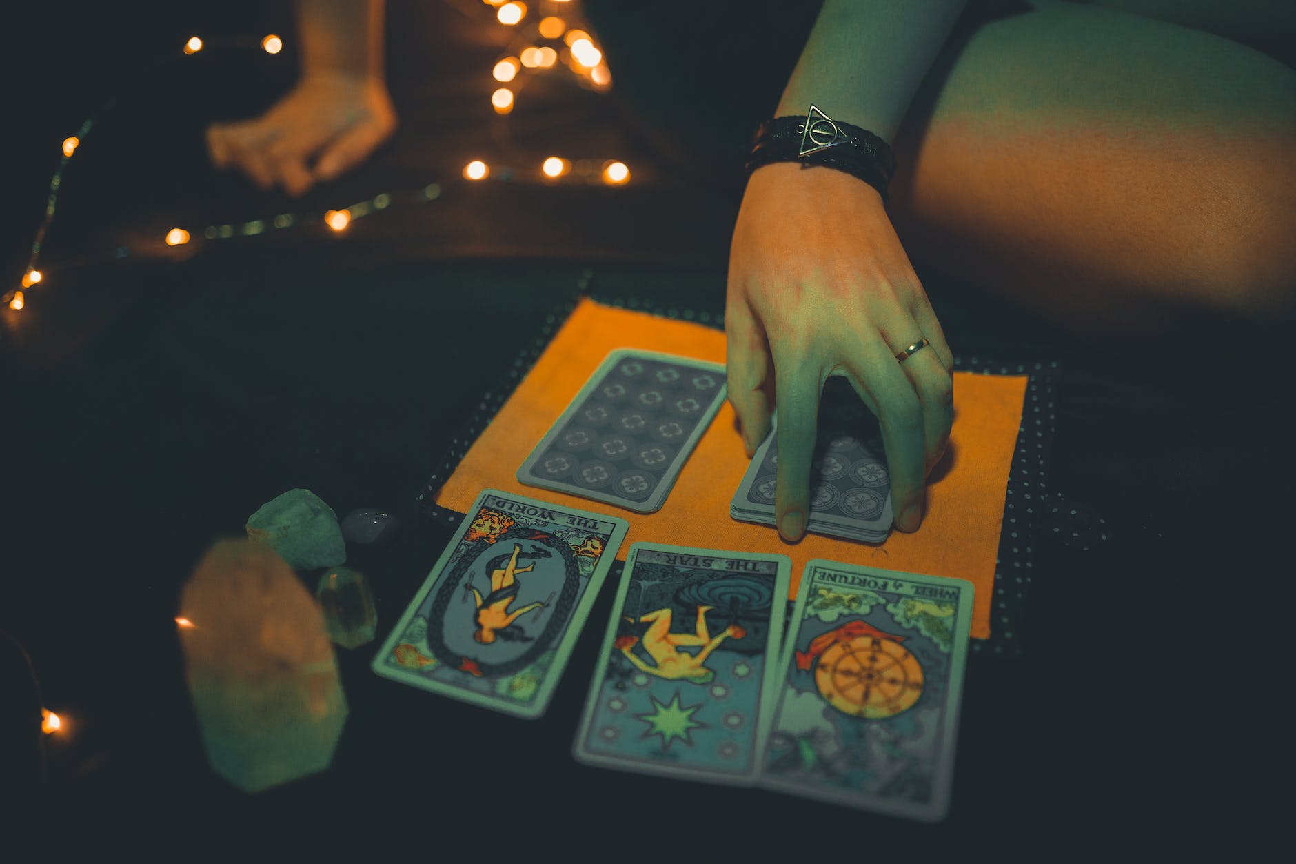 crop female future teller with tarot cards on table