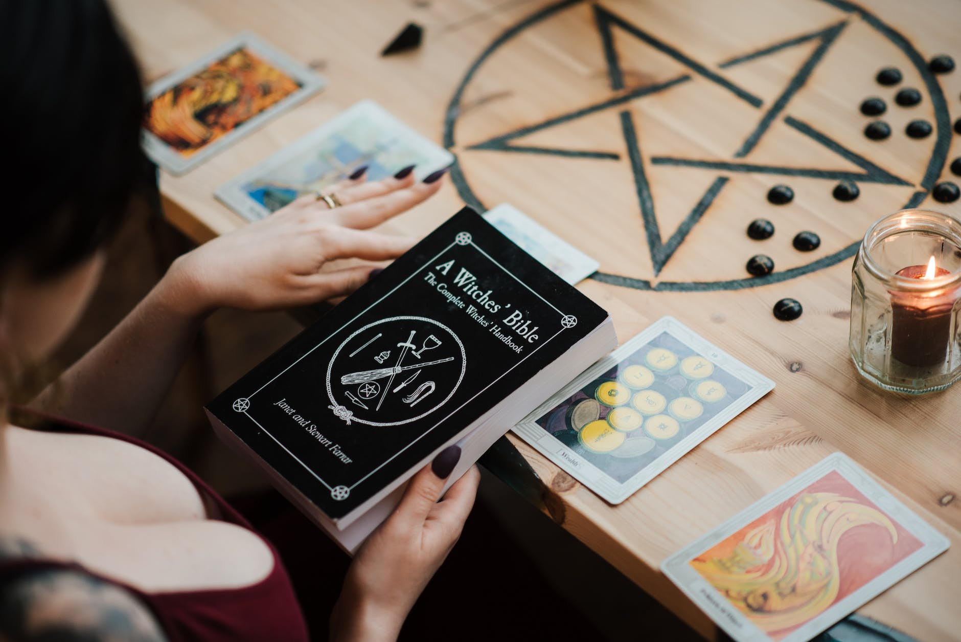 crop fortune teller with magic book and tarot cards