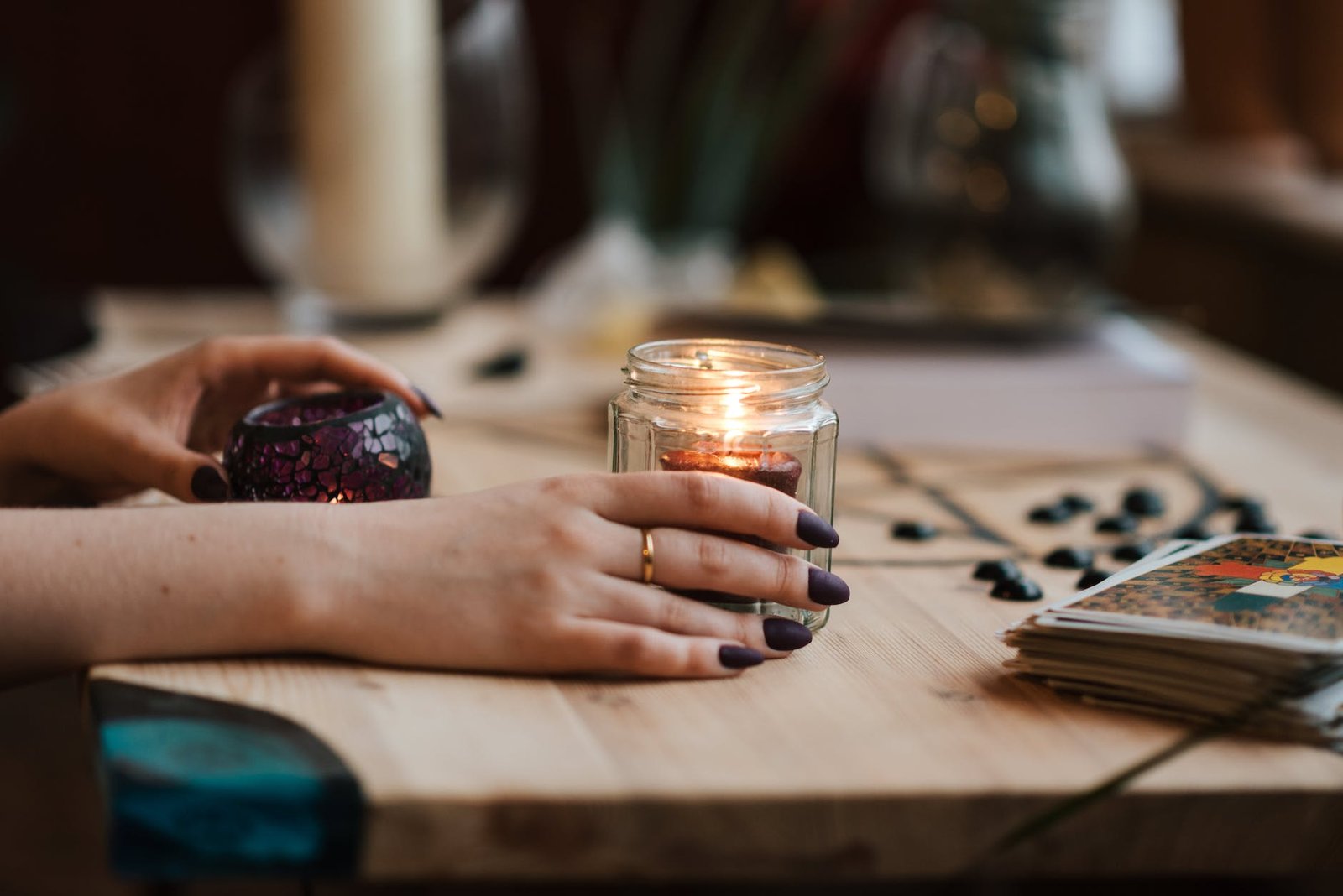 faceless fortune teller with burning candles at home