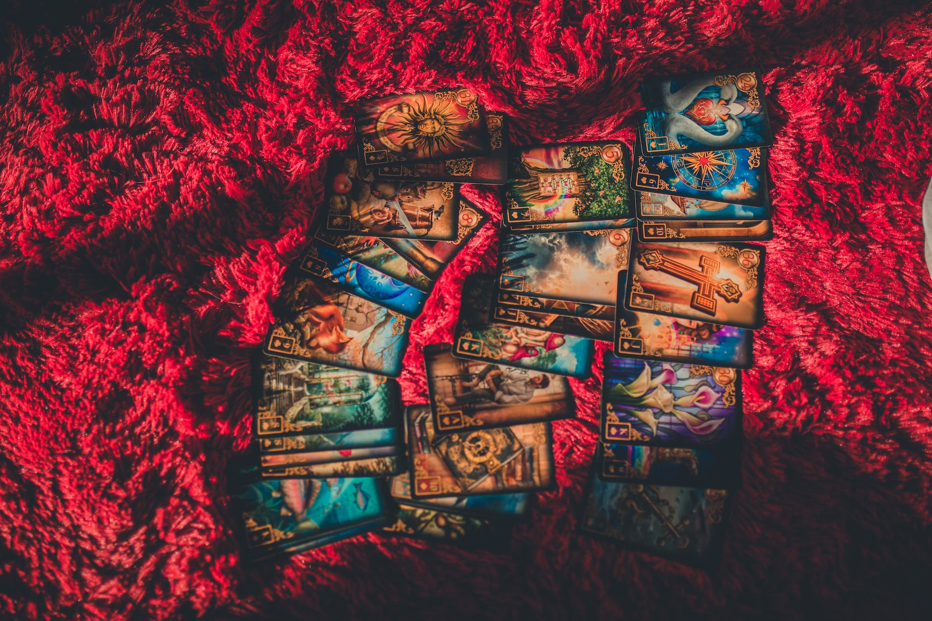 tarot cards laid out on red fabric