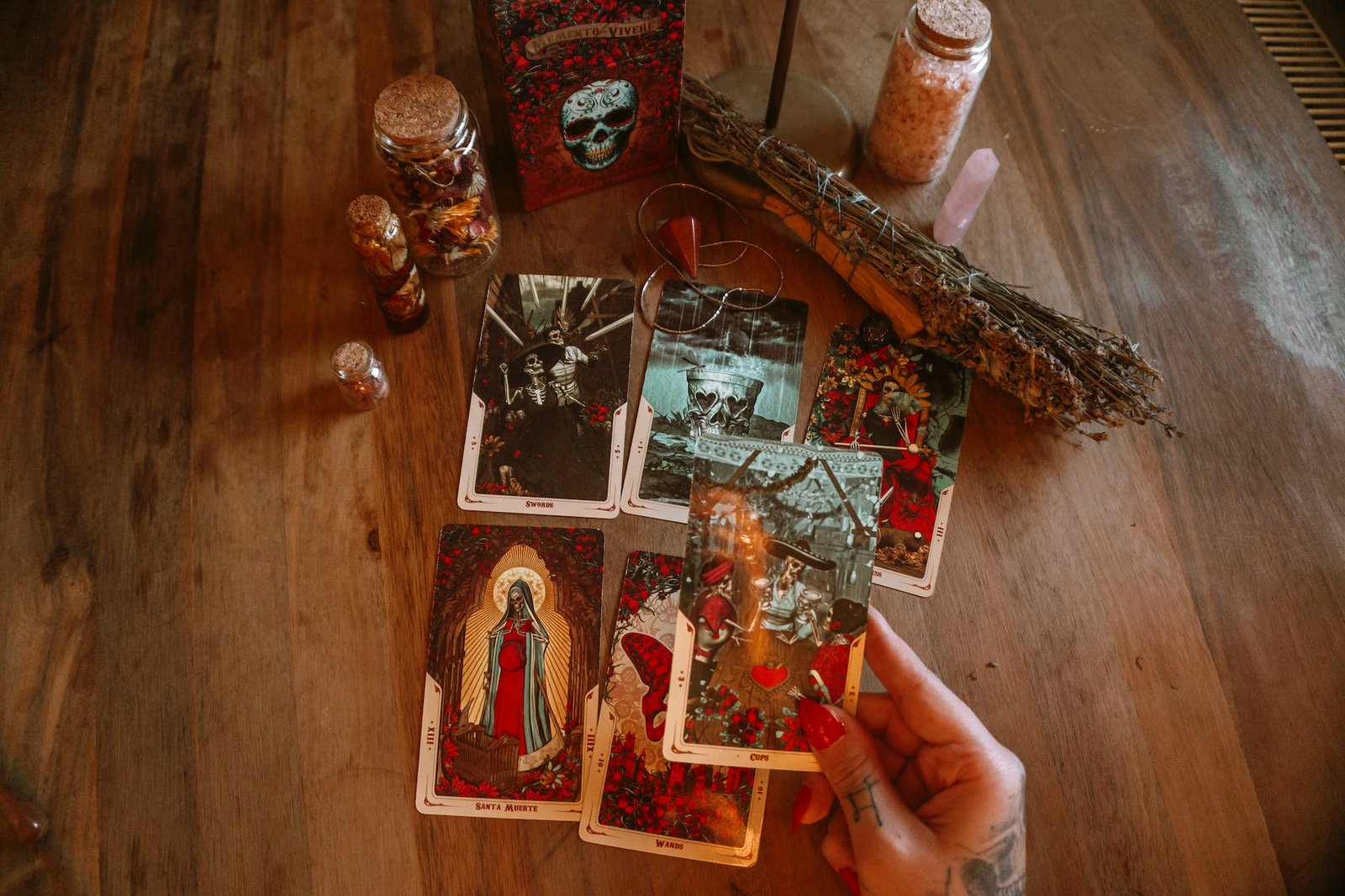 crop fortune teller laying out tarot cards on table