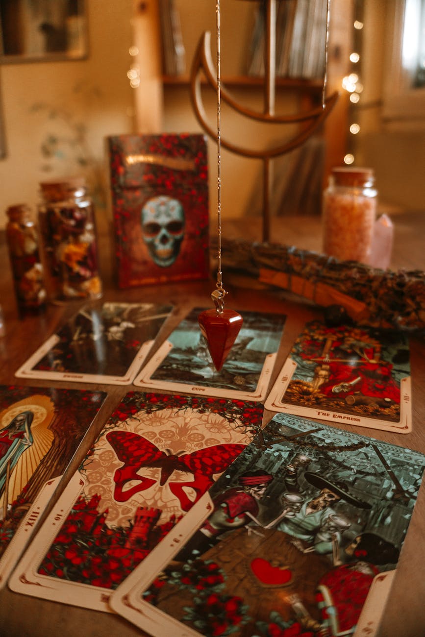tarot cards and decorative bottles on table at home