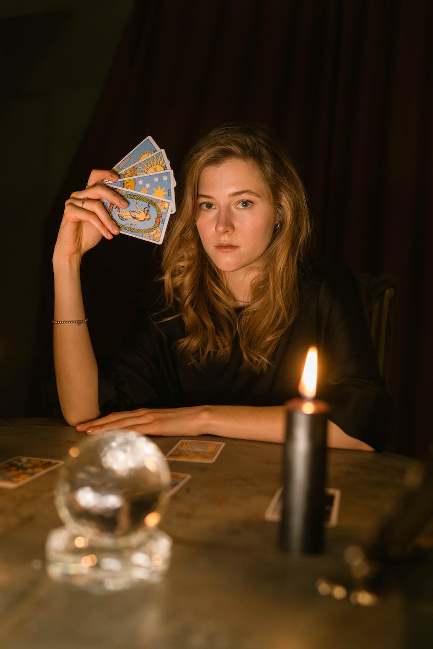 brunette woman holding tarot cards