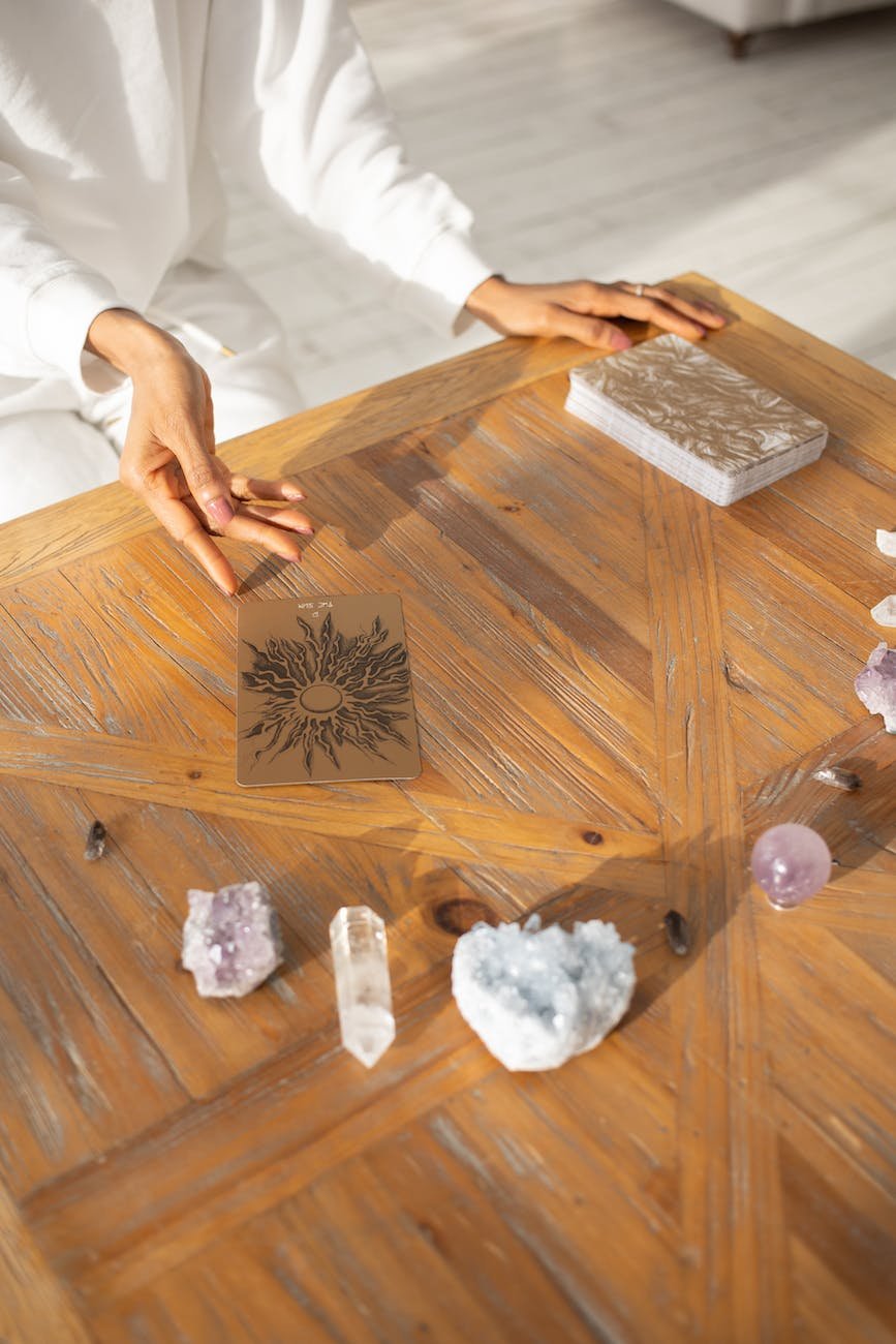 a woman sitting with tarot cards