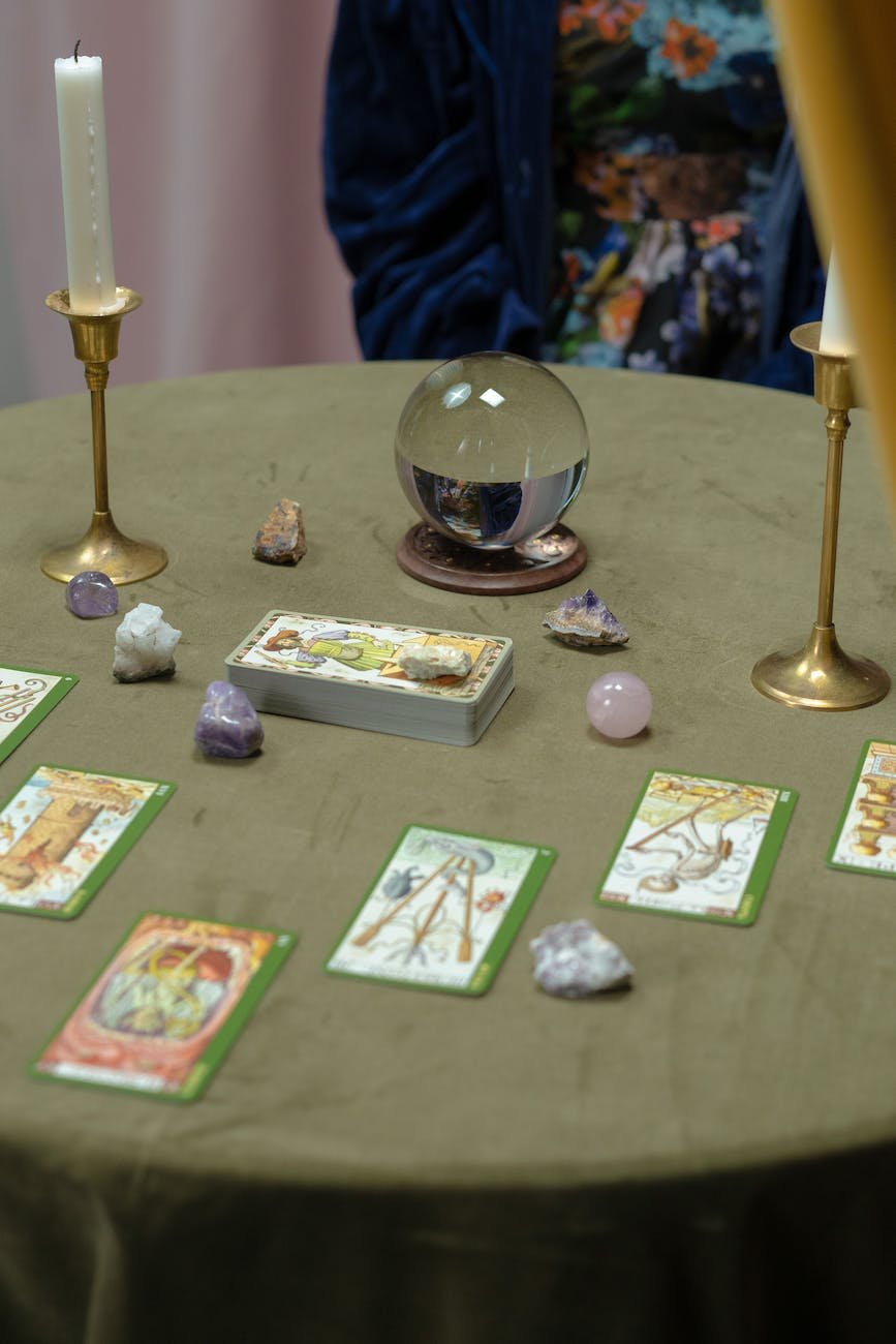 tarot cards and a crystal ball on the table