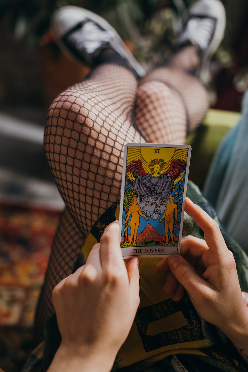person holding a tarot card