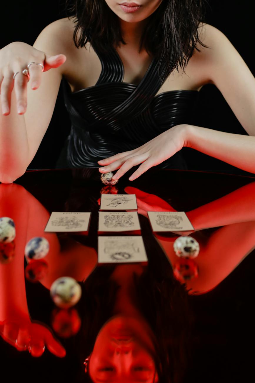 woman looking at tarot cards on glass table